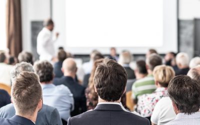 I have a question. Group of business people sitting at the chairs in conference hall. Businessman standing up asking a question. Conference and Presentation. Business and Entrepreneurship.